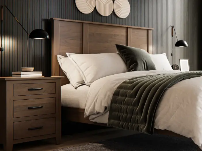 Solid wood bed frame with an upholstered headboard, matching wooden nightstands, and neutral bedding in a modern bedroom.